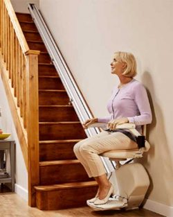 Woman seated on an Acorn 130 stair lift