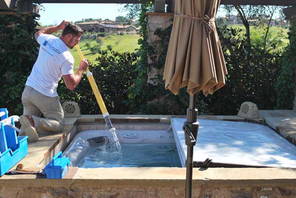 Man cleaning a hot tub.