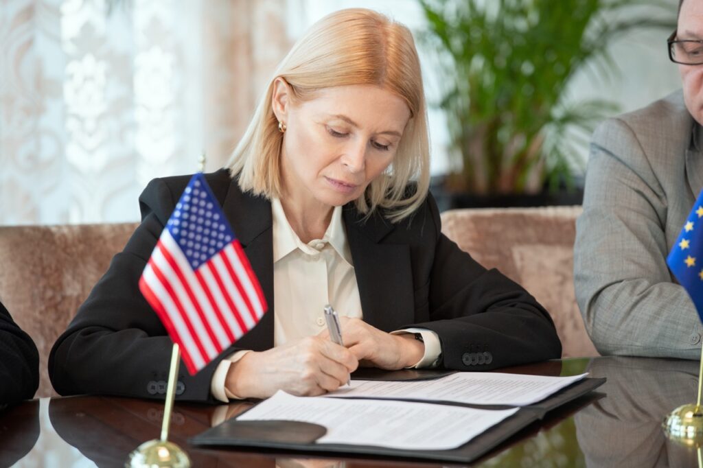 mature-american-delegate-in-formalwear-signing-con
