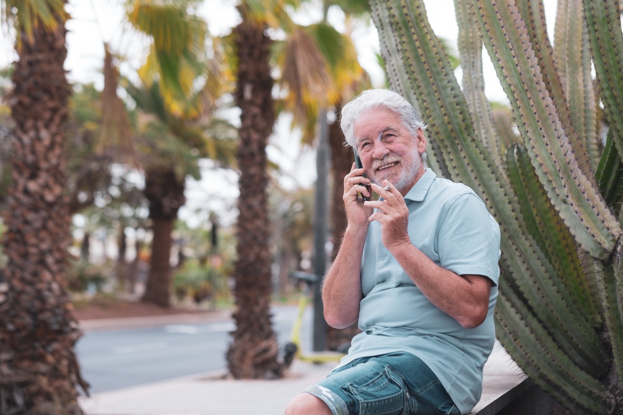 smiling-bearded-caucasian-senior-man-using-mobile