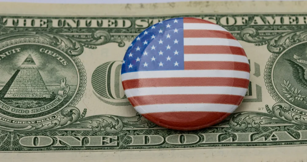 American flag pin on a dollar bill: Photo by Marek Studzinski on Unsplash