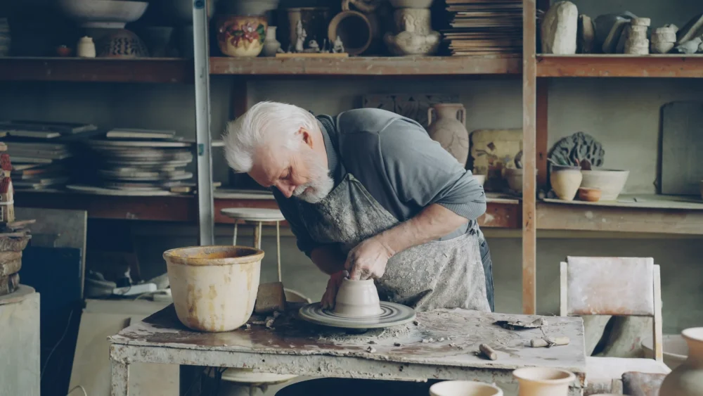 Old man in a pottery shop: Photo by Vitaly Gariev on Unsplash