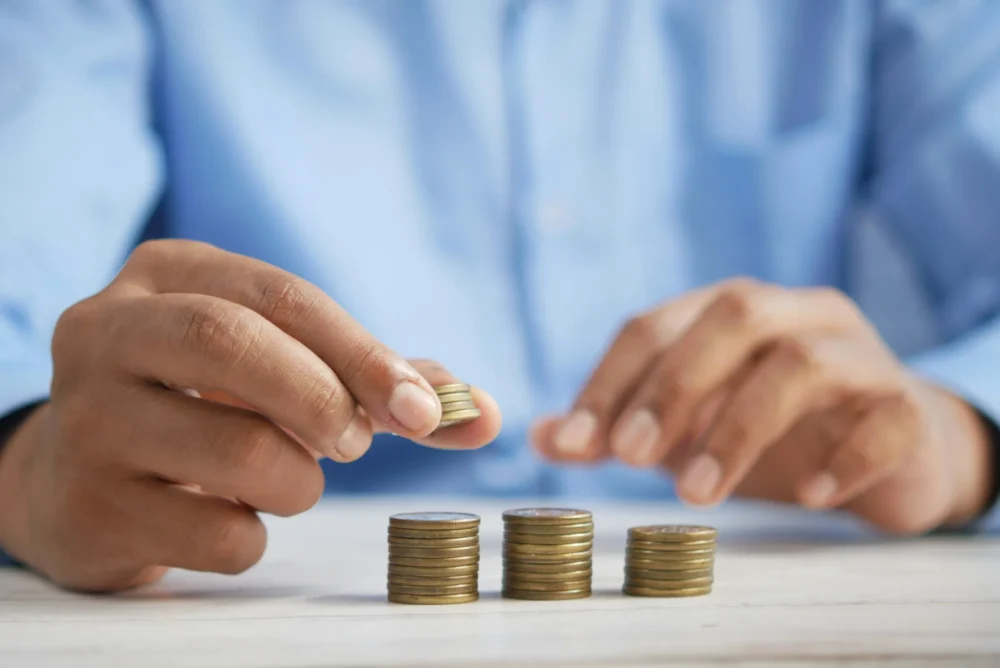 Person counting coins: Photo by Towfiqu barbhuiya on Unsplash