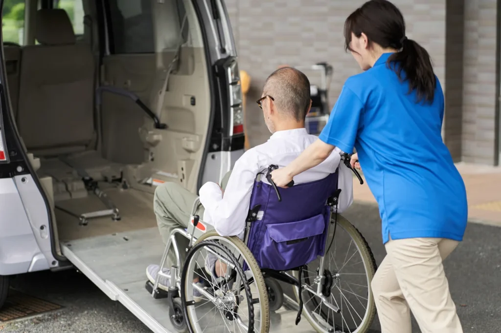 a-caregiver-who-puts-an-elderly-person-in-a-car