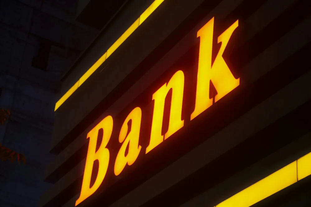 Yellow bank sign: Photo by POURIA on Unsplash