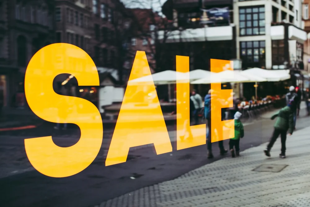 Black Friday Sale sign with city reflected in glass: Photo by Markus Spiske on Unsplash