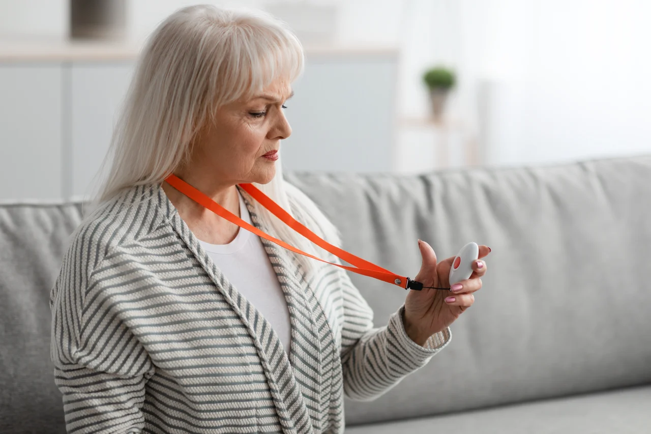 emergency-call-system-senior-woman-holding-alarm